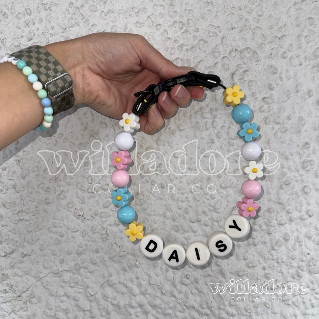 Custom beaded dog collar with pastel round and flower beads and DAISY name letters, showing a personalized design option for Willadore Collar Co.’s handmade beaded dog collars