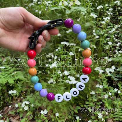Custom beaded pet collar with multicolor beads and FLORA name letters, highlighting Willadore Collar Co.’s personalized handmade beaded collars.