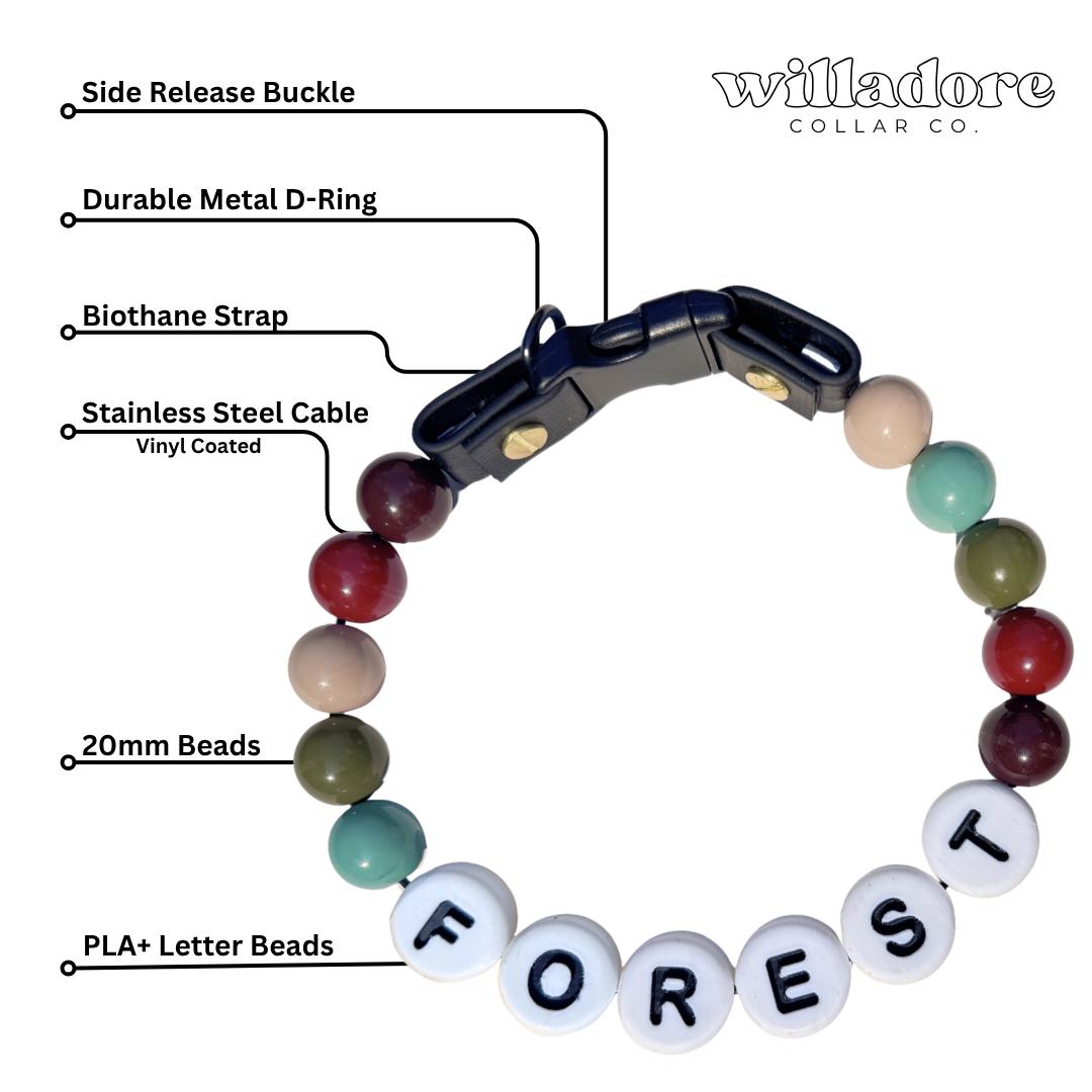 Labeled diagram of a custom beaded dog collar with forest‑tone beads and FOREST name letters, featuring durable hardware and handmade construction by Willadore Collar Co.