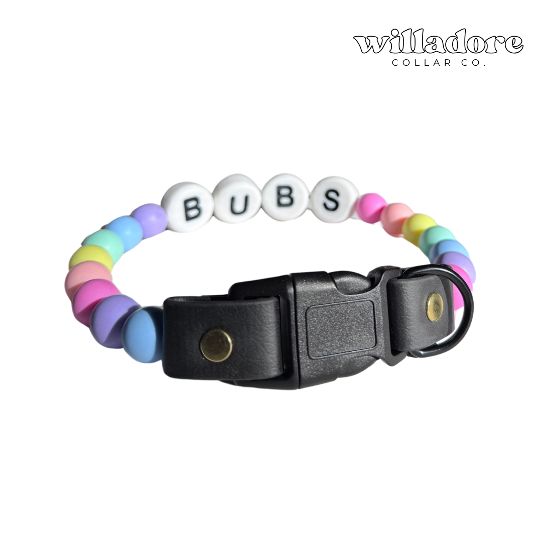 Custom beaded dog collar with pastel beads and BUBS name letters on a black adjustable strap, showing a personalized design option for Willadore Collar Co.’s handmade beaded dog collars