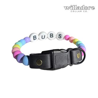 Custom beaded dog collar with pastel beads and BUBS name letters on a black adjustable strap, showing a personalized design option for Willadore Collar Co.’s handmade beaded dog collars